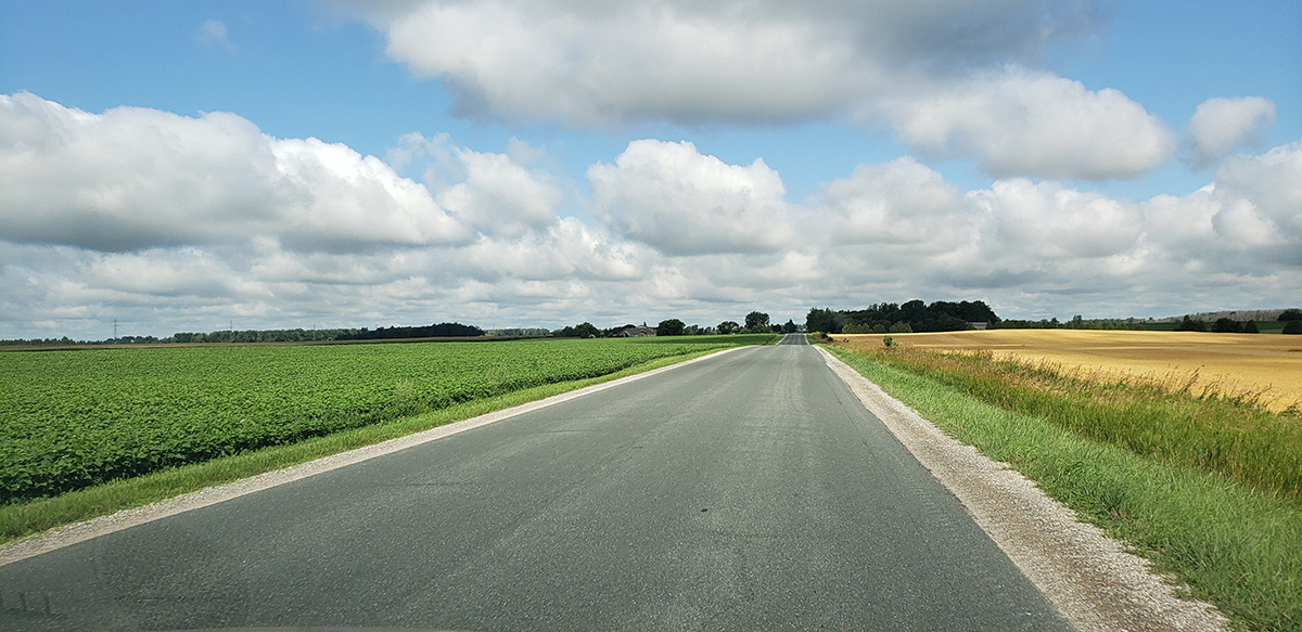 Scenic road view with clouds in the sky